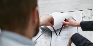5 Different Ways You Can Become a Loan Investor Investor reviewing loan agreement documents