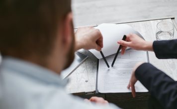 5 Different Ways You Can Become a Loan Investor Investor reviewing loan agreement documents